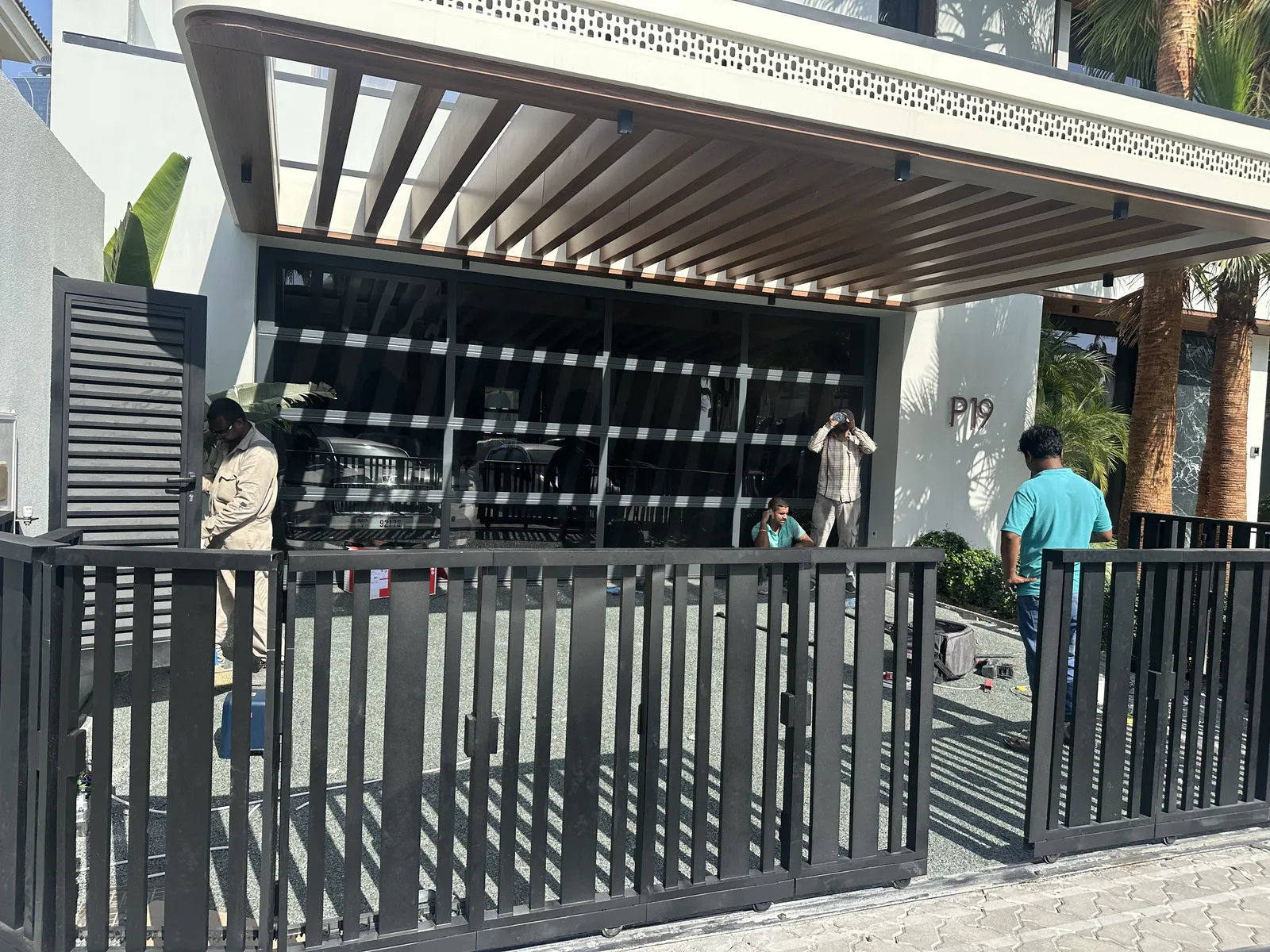 Steel pergola and gate at villa entrance